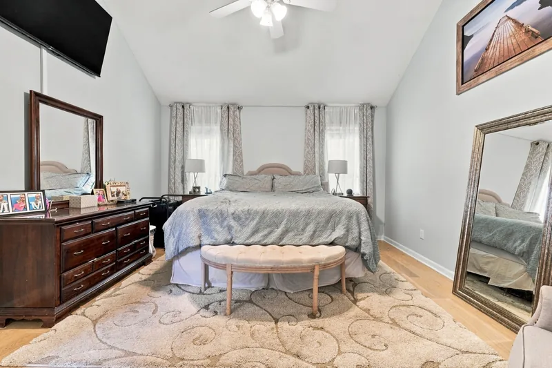 First-floor primary bedroom with a vaulted ceiling