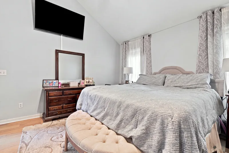 First-floor primary bedroom with a vaulted ceiling